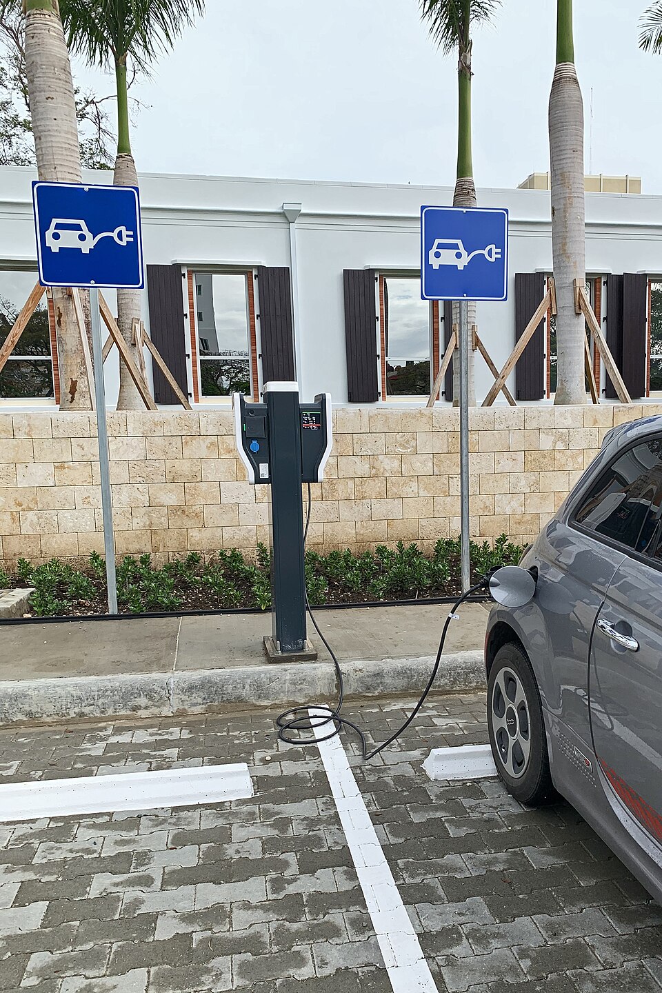 EV parked and charging at a curbside charging bay